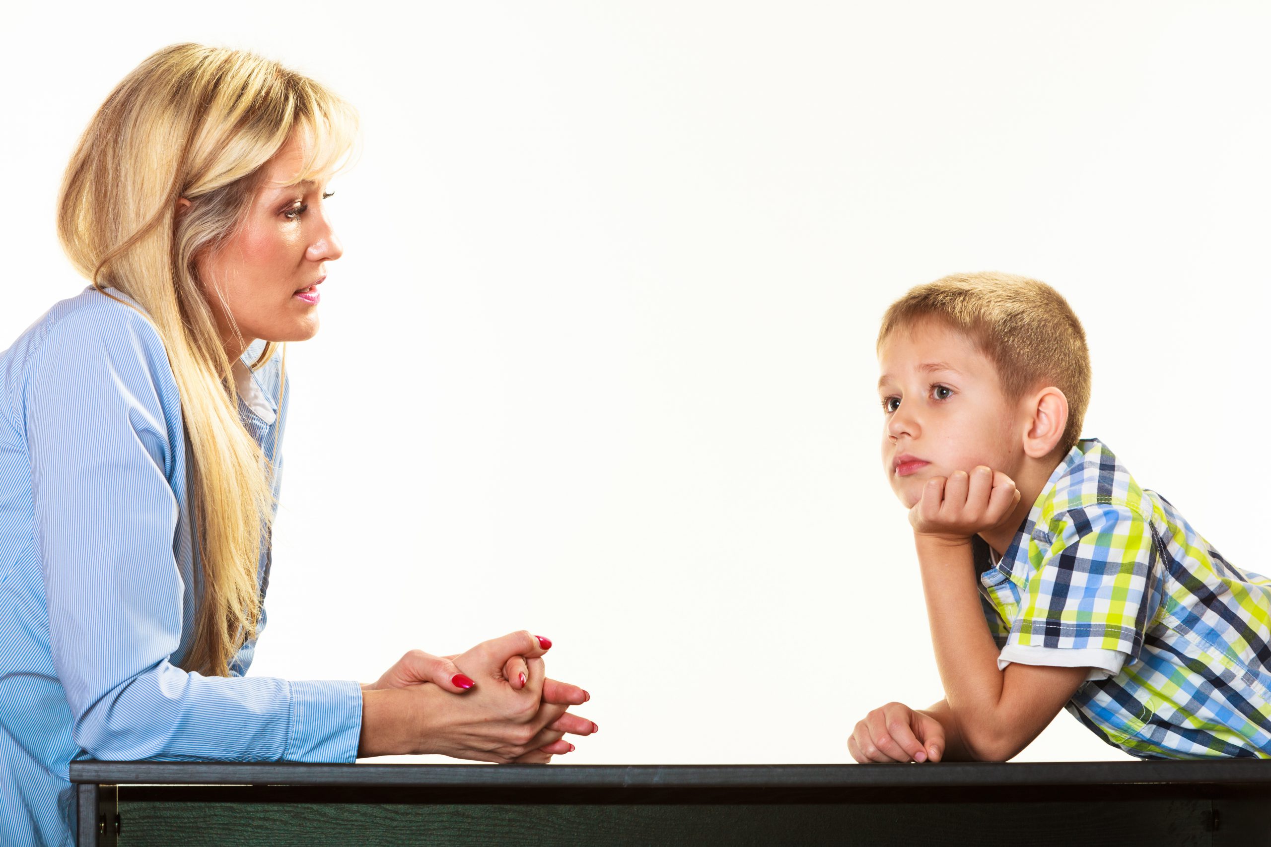 Parenthood domestic life and children upbringing. Mother talking with son little sad boy isolated on white background